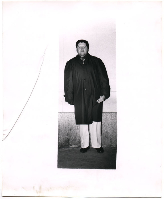 Man standing outside against wall