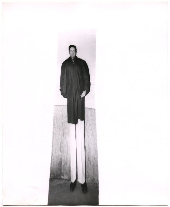 Man standing outside against wall (distortion)