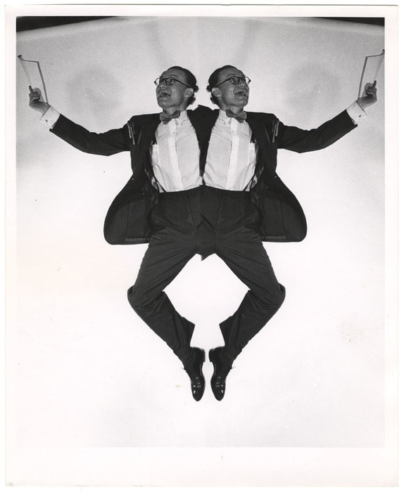 Man jumping with pad and pencils (distortion)