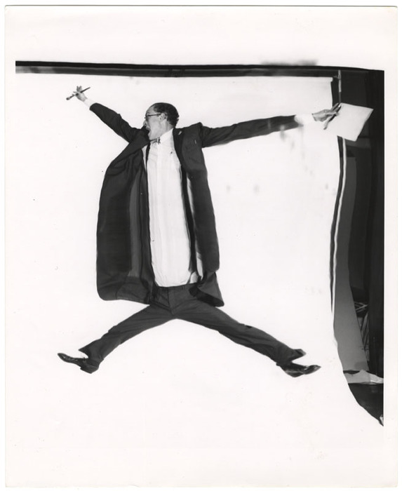 Man jumping with pad and pencils (distortion)