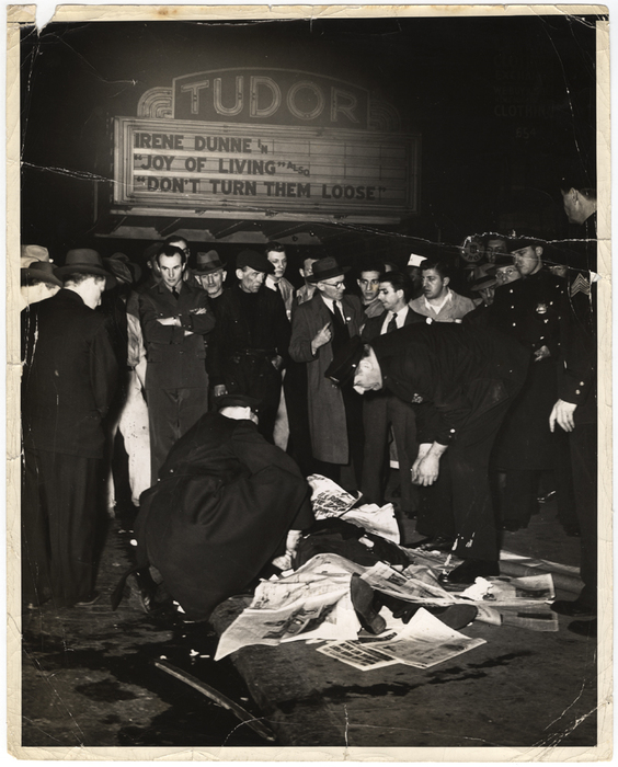 [Police and bystanders with body of Stanley Sandler, a passenger in an automobile that crashed into a Third Avenue El pillar and caught fire, New York]