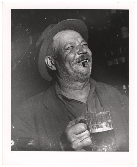 [Man holding mug of beer]
