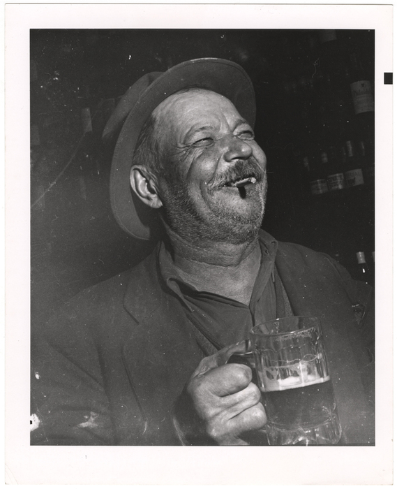[Man holding mug of beer]
