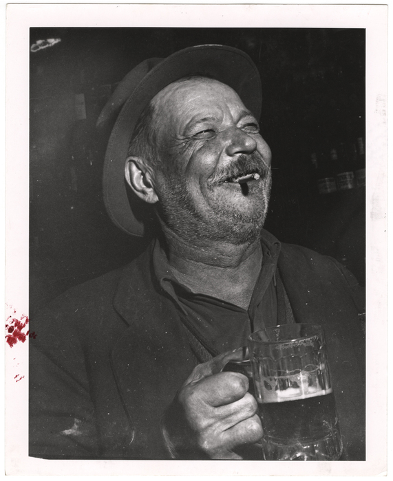 [Man holding mug of beer]