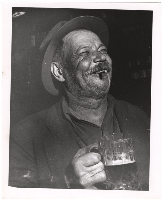 [Man holding mug of beer]