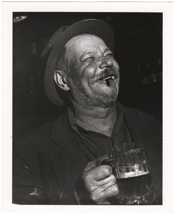 [Man holding mug of beer]