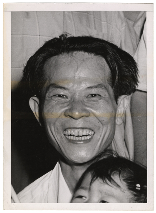 [Man, laughing, with boy]