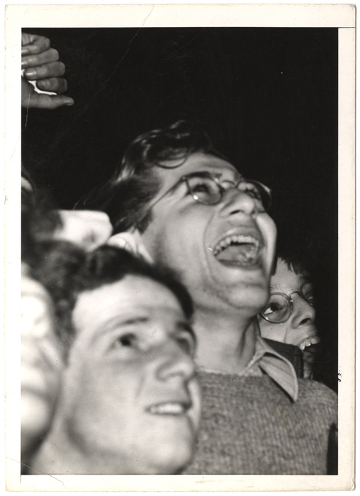 [Men watching scoreboard of World Series at Yankee Stadium in upper window of Sachs Furniture Company store, New York]