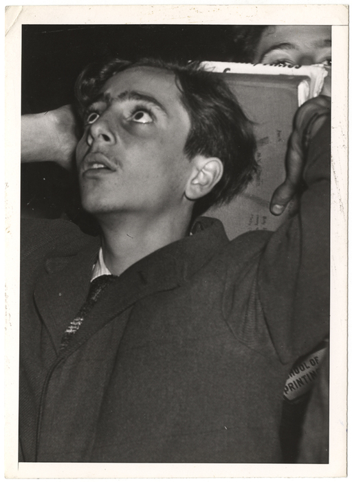 [Man watching scoreboard of World Series at Yankee Stadium in upper window of Sachs Furniture Company store, New York]