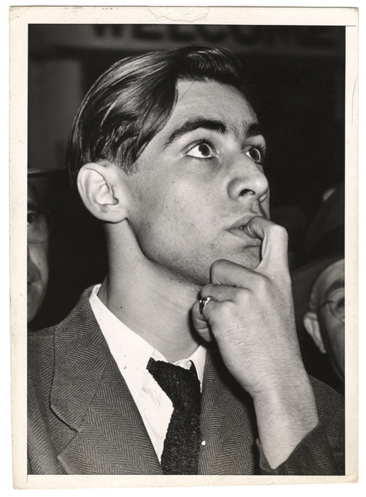[Man watching scoreboard of World Series at Yankee Stadium in upper window of Sachs Furniture Company store, New York]