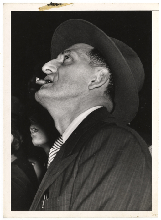 [Man watching scoreboard of World Series at Yankee Stadium in upper window of Sachs Furniture Company store, New York]