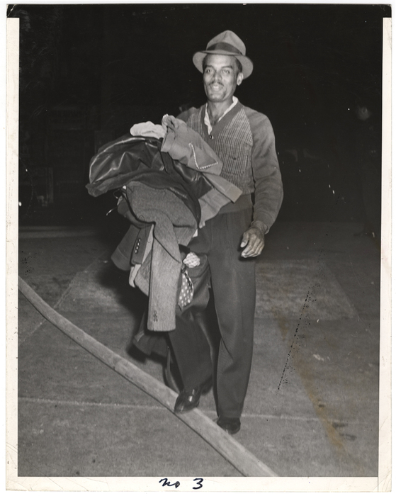 [Man with clothes stepping over hose]