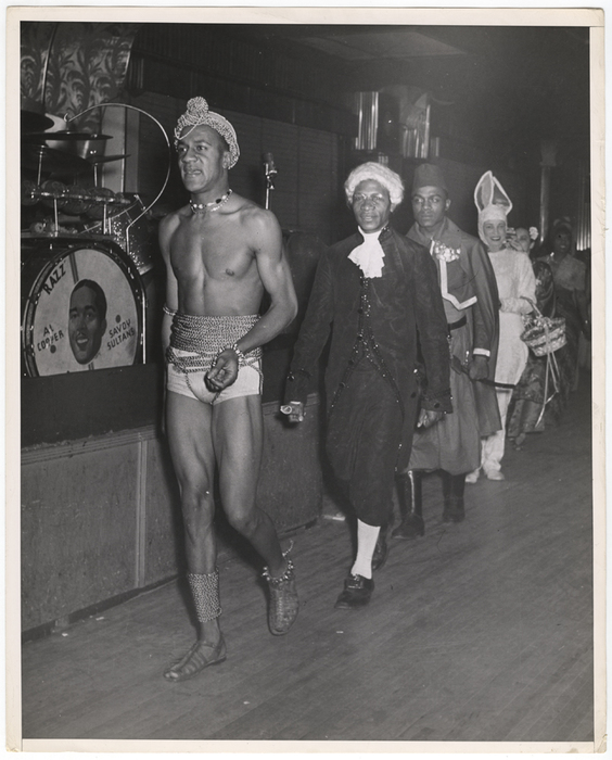 "This is how the parade of costume - wearers looked as they marched past the judges. The costumes, our photographer reports, were strange and original."