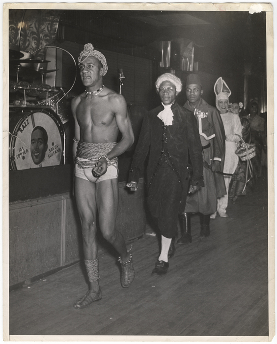 "This is how the parade of costume - wearers looked as they marched past the judges. The costumes, our photographer reports, were strange and original."