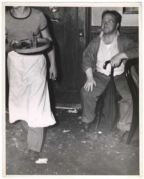 [Man with umbrella in a bar]