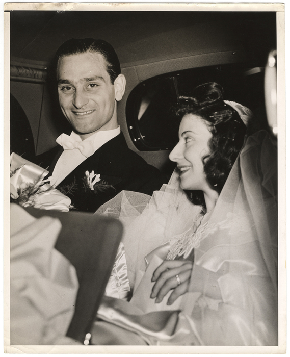 [Bride and groom in car]