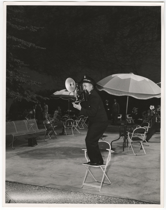 [Member of the Salvation Army with Speed Graphic camera]