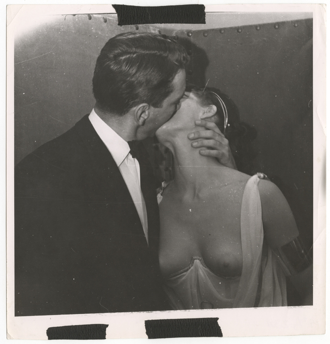 [Man kissing costumed woman]