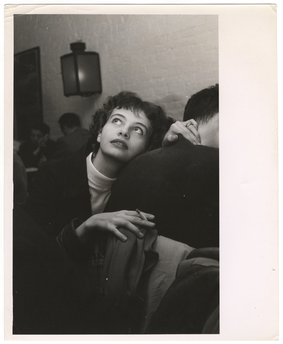 [woman looking up and smoking, at the Limelight]