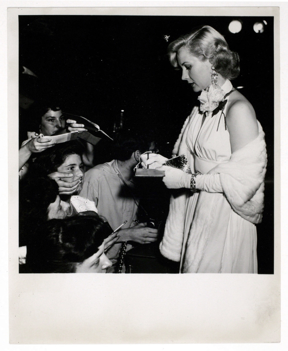 [Virginia Mayo signing autographs at a movie premiere]