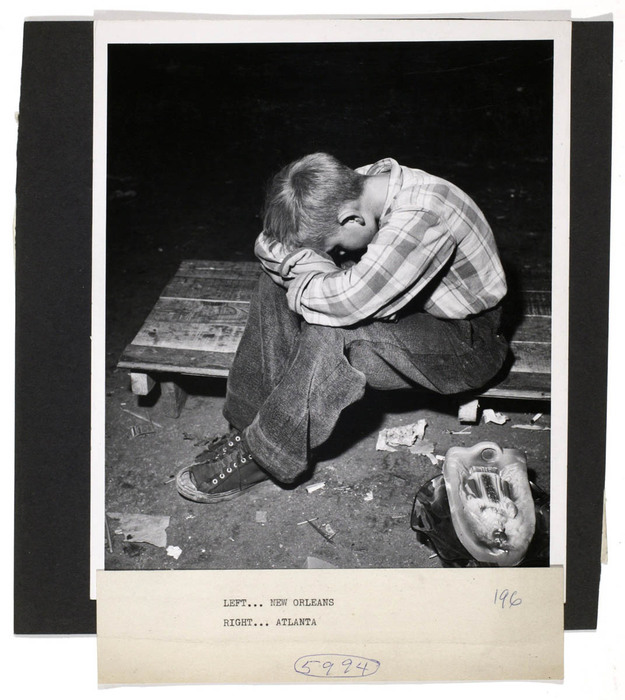 [Man sleeping on sacs, next to barrels of peas]