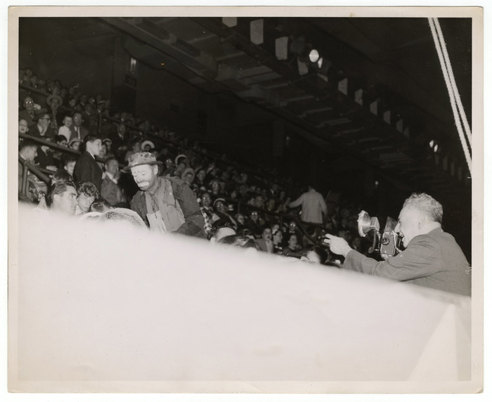[Weegee photographing Emmett Kelly among audience members at circus]