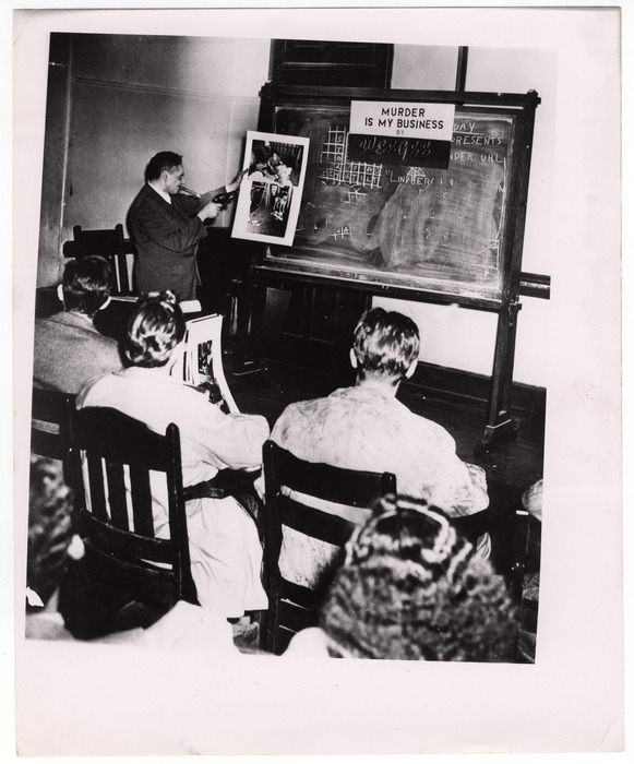 [Weegee delivering lecture called "Murder is My Business"]