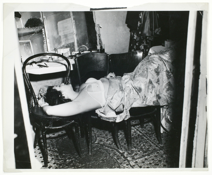 [Performer sleeping on chairs in dressing room]