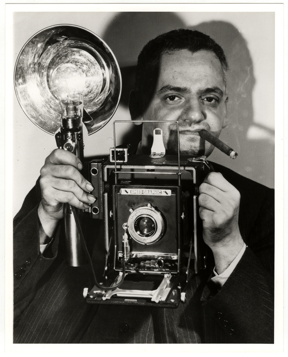 [Weegee with his Speed Graphic camera]