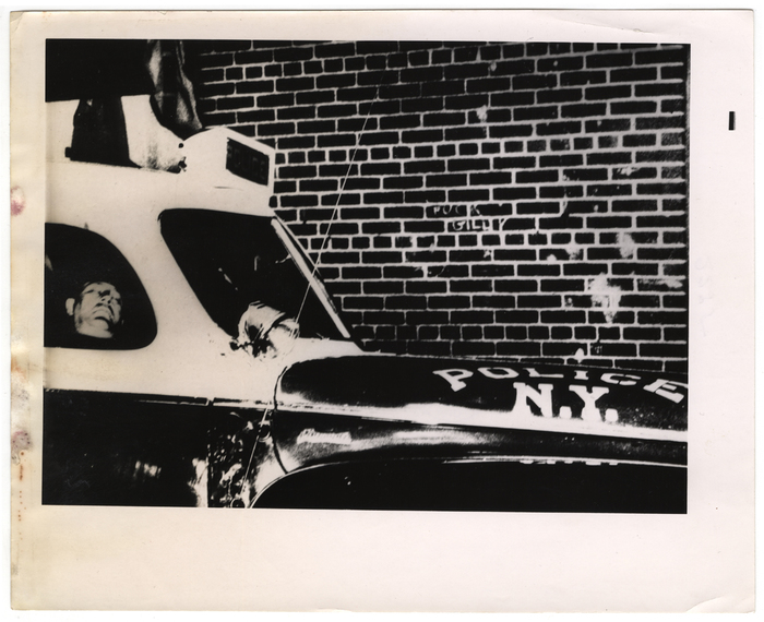 [Police officer sleeping in police car]