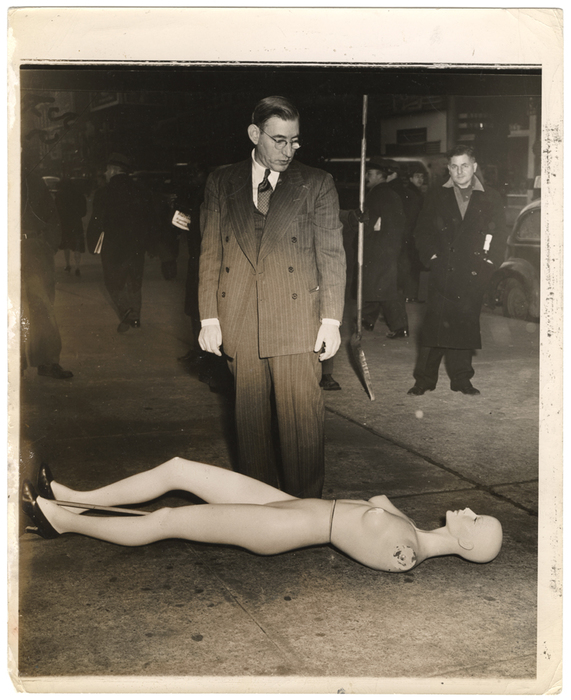 [Morris Goodovitch, owner of Arnold’s apparel shop, looking at mannequin from burgled store, New York]