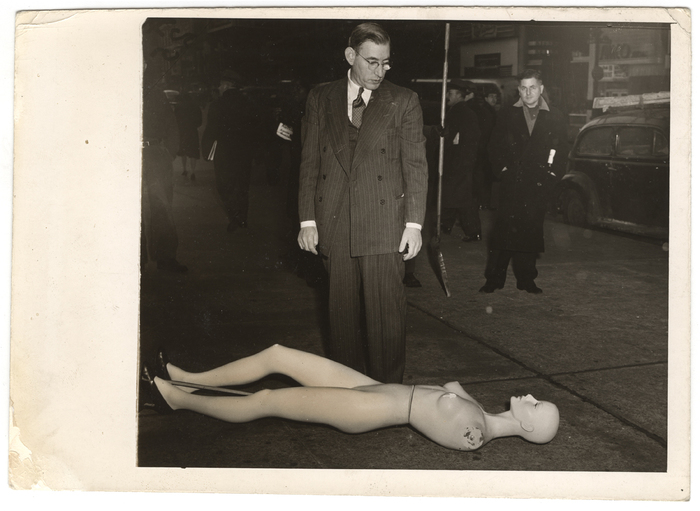 [Morris Goodovitch, owner of Arnold’s apparel shop, looking at mannequin from burgled store, New York]