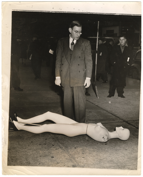 [Morris Goodovitch, owner of Arnold’s apparel shop, looking at mannequin from burgled store, New York]