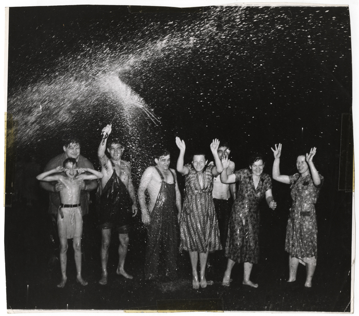 [Adults and children playing in open fire hydrant on hottest day of year, New York]