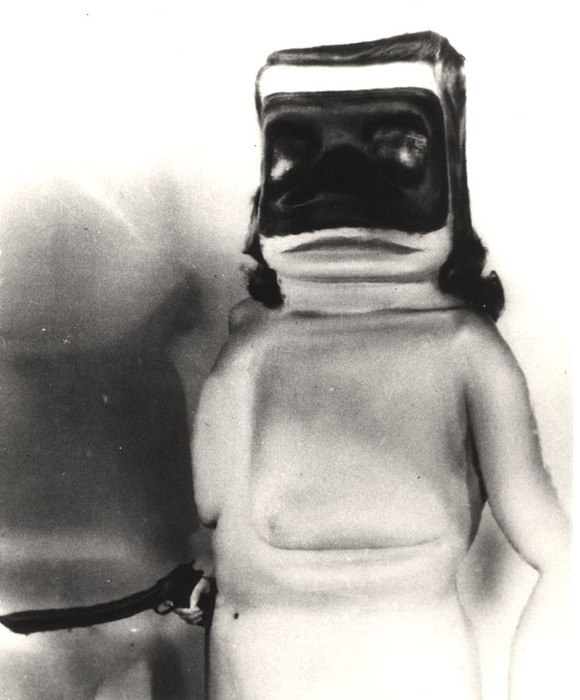 [Masked female nude with gun distortion]