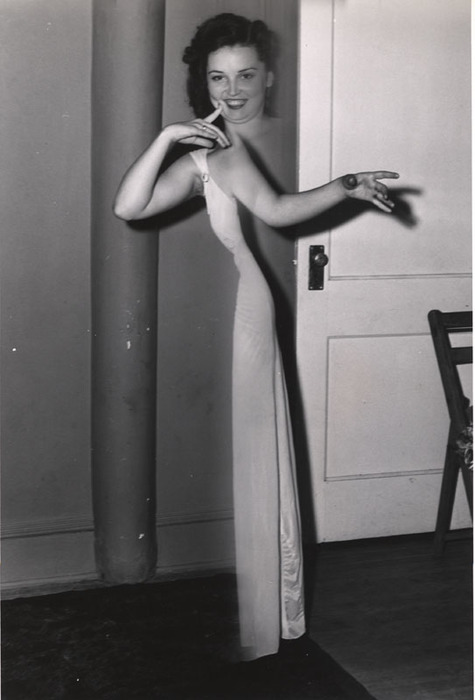 (Smiling Woman, In Front of Door, Pointing)