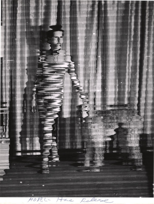 (Model wearing striped jumpsuit, with dog)