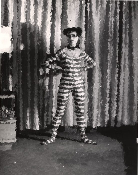 (Model wearing striped jumpsuit, with arms akimbo)