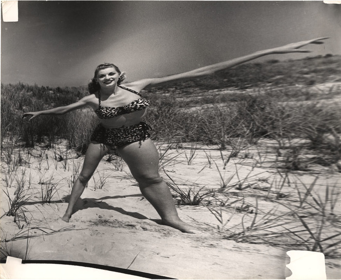 Blonde on beach standing in the sand