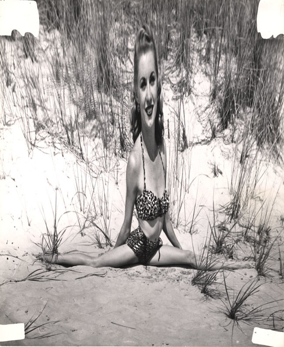 Blonde on beach sitting in the sand