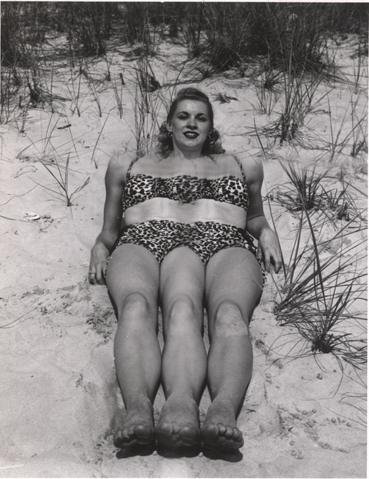 Blonde on beach sitting in the sand
