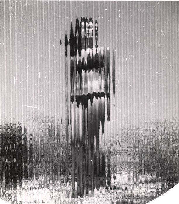 (Model on beach, wearing black bikini)