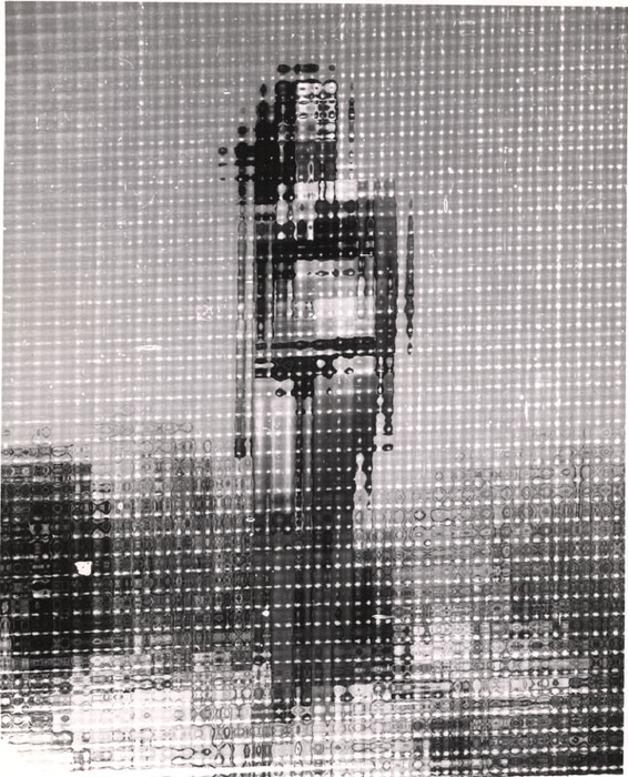 (Model on beach, wearing black bikini)