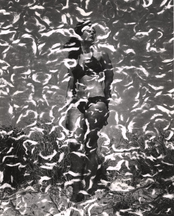 (Model on beach, wearing black bikini)