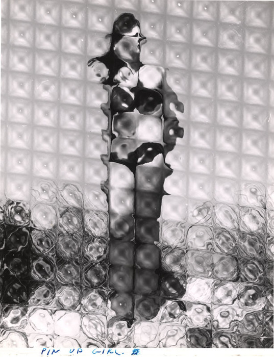 (Model on beach, wearing black bikini)