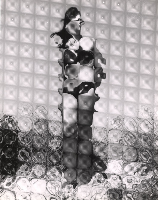 (Model on beach, wearing black bikini)