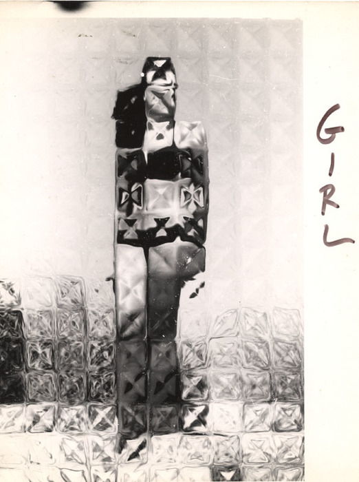 (Model on beach, wearing black bikini)