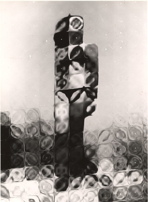 (Model on beach, wearing black bikini)