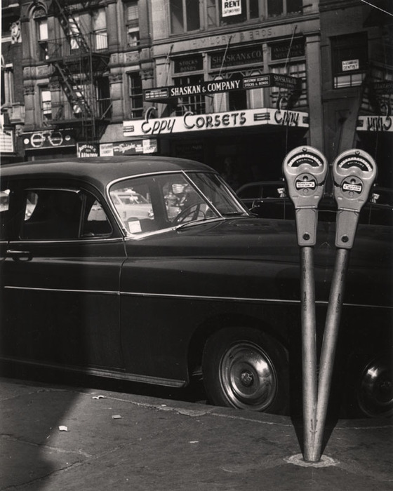 [Parking meters, car and corset store]