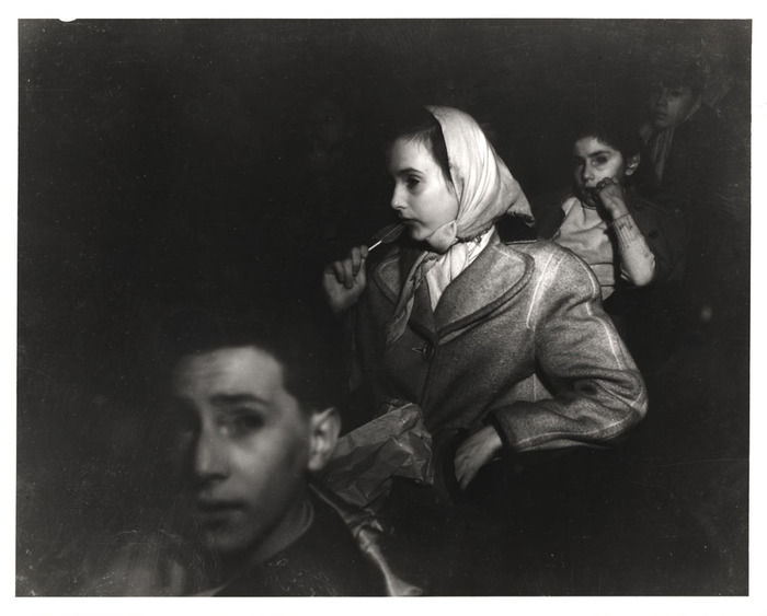 Girl eating lollipop in movie theatre